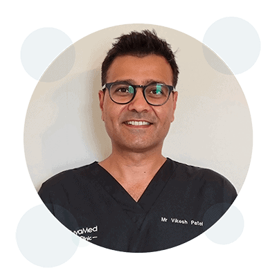 Professional headshot of Mr Vikash Patel wearing glasses