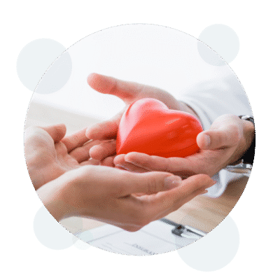 Two hands holding a red heart shape together