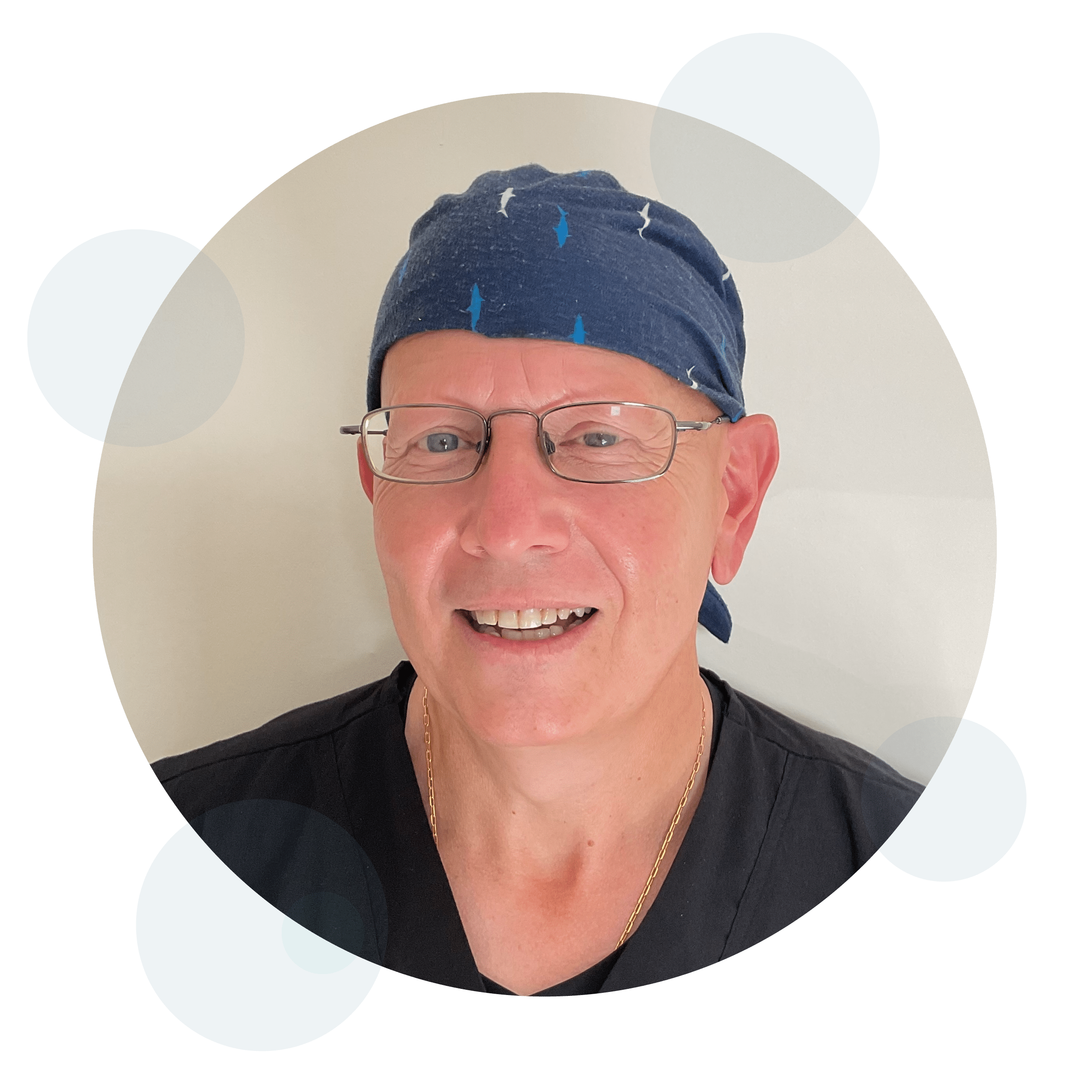 Smiling man wearing glasses and navy blue headband