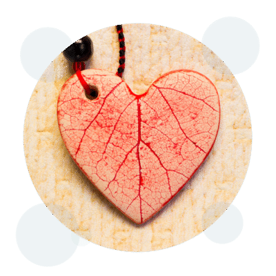 Red leaf-veined heart shape on textured beige background