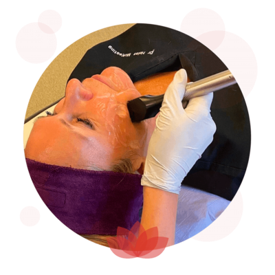 Rejuvamed – 2023 Treatment Bubbles2 Professional applying orange face paint with brush and gloves