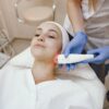 CO2 Laser Skin Resurfacing Aesthetician performing radiofrequency skin treatment on patient's neck